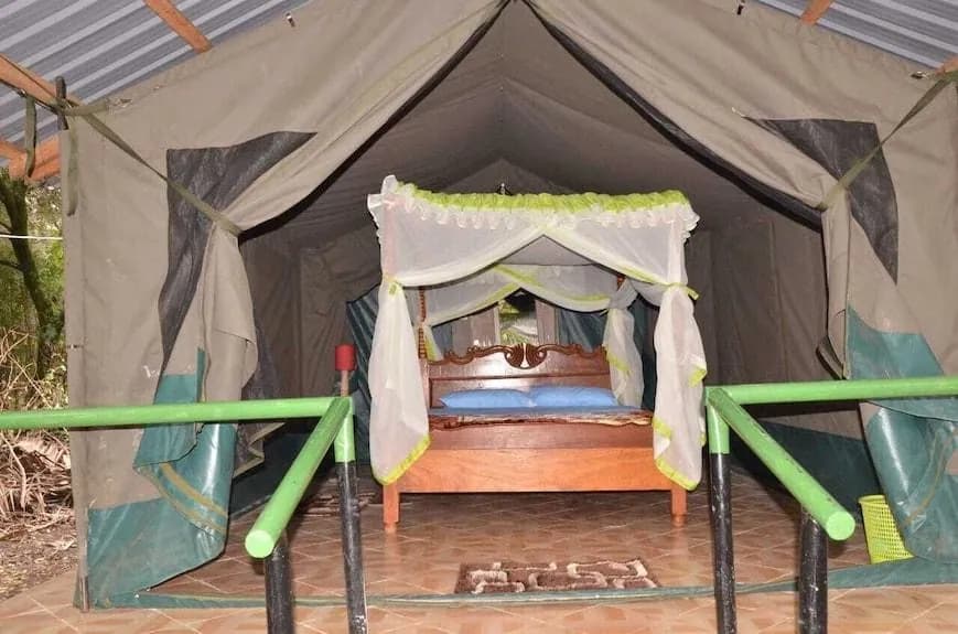 Bed inside a tented room at Miti Mingi Eco Camp
